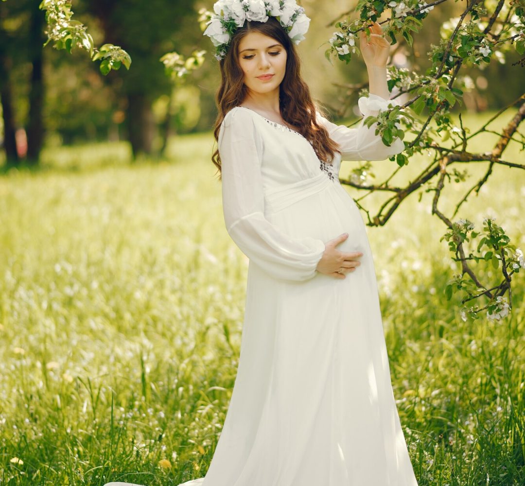beautiful-young-pregnant-girl-long-white-dress-wreath-her-head_1157-13874