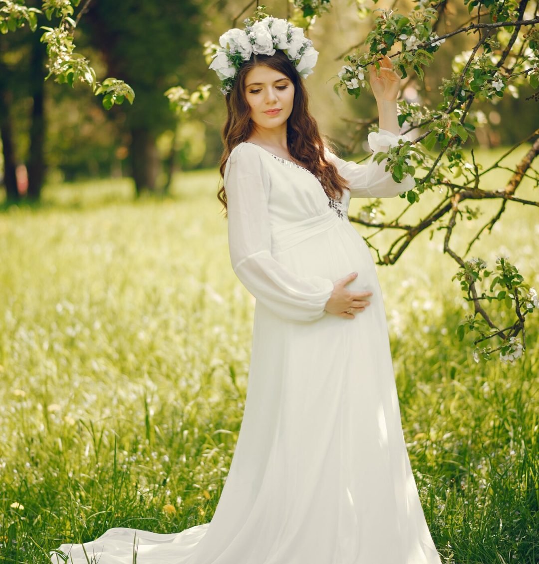 beautiful-young-pregnant-girl-long-white-dress-wreath-her-head_1157-13874